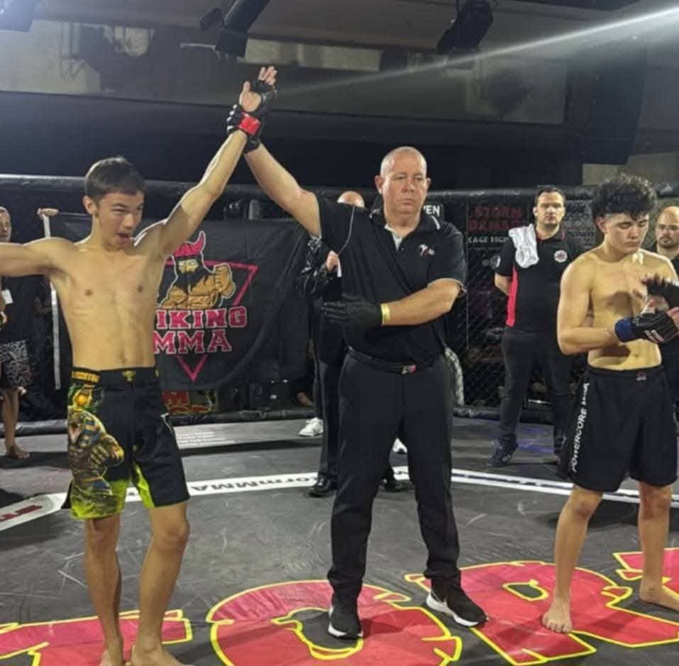 A Viking MMA fighter has his hand raised after a first-round win at Storm Damage 20